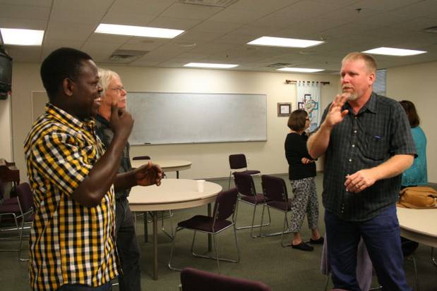 Paul Aseka and another gentleman conversing with ASL
