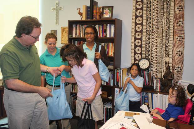 Tom Hudspeth and several people in a study, packing bags.